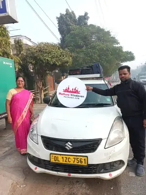 Swift Dzire taxi and driver with Mathura Vrindavan Package board