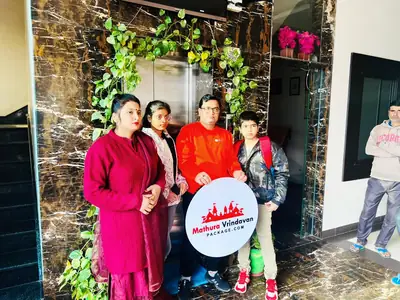 Family in hotel lobby with Mathura Vrindavan Package board